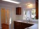 Kitchen with double sink, wood cabinets, and view to entry at 6349 Elevation Rd, Benson, NC 27504