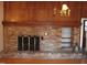 Brick fireplace with wood paneling and shelving at 6349 Elevation Rd, Benson, NC 27504