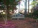 Wooden garden bench surrounded by blooming camellias at 6349 Elevation Rd, Benson, NC 27504