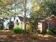 Side view showcasing the brick exterior and landscaping at 6349 Elevation Rd, Benson, NC 27504