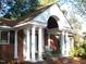 Front porch detail featuring columns and arched entryway at 6349 Elevation Rd, Benson, NC 27504