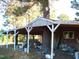 Rustic covered porch with a tree growing through the supports at 6349 Elevation Rd, Benson, NC 27504