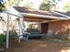 Carport with a swing and brick exterior at 6349 Elevation Rd, Benson, NC 27504