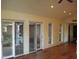 Living room with hardwood floors and multiple sliding glass doors at 6349 Elevation Rd, Benson, NC 27504