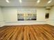 Large great room with hardwood floors and scenic artwork at 3419 Oak Trl, Clayton, NC 27520