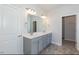 Double vanity bathroom with gray cabinets and a large mirror at 110 Lemon Drop Ln, Franklinton, NC 27525