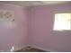 Pink bedroom with wood floors and window at 6383 Elevation Rd, Benson, NC 27504