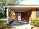 Brick ranch home with covered front porch and white columns at 6383 Elevation Rd, Benson, NC 27504