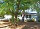 White ranch style home partially obscured by trees at 6383 Elevation Rd, Benson, NC 27504