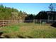 Side yard with chain link fence and overgrown grass at 6383 Elevation Rd, Benson, NC 27504