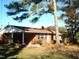 Brick ranch house with covered porch and large tree in front yard at 6383 Elevation Rd, Benson, NC 27504