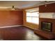 Living room with brick fireplace and hardwood floors at 6383 Elevation Rd, Benson, NC 27504