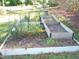 Raised garden beds with various plants and flowers at 6383 Elevation Rd, Benson, NC 27504