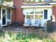 Small back patio with old patio furniture and grill at 6383 Elevation Rd, Benson, NC 27504