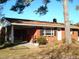 Brick ranch house with covered porch, mature landscaping, and a spacious yard at 6383 Elevation Rd, Benson, NC 27504