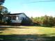 White side of ranch home with landscaping and trees at 6383 Elevation Rd, Benson, NC 27504
