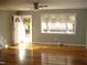 Bright living room with hardwood floors and large window at 6383 Elevation Rd, Benson, NC 27504