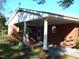 Brick home features a covered porch with white columns at 6383 Elevation Rd, Benson, NC 27504
