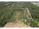 Aerial view of a large property with mature trees and a home at 6383 Elevation Rd, Benson, NC 27504