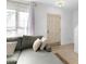 Living room with gray sectional sofa, built in shelving and entryway at 1812 Orange Grove Rd # 101, Hillsborough, NC 27278