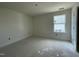 Well-lit bedroom with window and neutral walls at 1505 Maelyn Way, Fuquay Varina, NC 27526