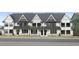 Three-story townhomes with modern farmhouse style, gray and white exterior at 901 Myers Point Dr # 17, Morrisville, NC 27560