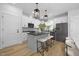 Modern kitchen with gray island, white cabinets, and black appliances at 901 Myers Point Dr # 17, Morrisville, NC 27560