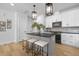 Modern kitchen with gray island, white cabinets, and black appliances at 901 Myers Point Dr # 17, Morrisville, NC 27560
