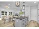 Modern kitchen island with seating, open to living area, with white cabinets and gray island at 901 Myers Point Dr # 17, Morrisville, NC 27560