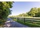 Paved walking trail beside a wooden fence at 901 Myers Point Dr # 17, Morrisville, NC 27560