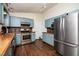 Modern kitchen with stainless steel appliances and copper countertops at 928 Magnolia Ridge Way, Fuquay Varina, NC 27526