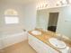 Main bathroom with double vanity and soaking tub at 6220 Sweden Dr, Raleigh, NC 27612
