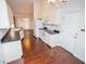 Kitchen with white cabinets, dark countertops, and hardwood floors at 6220 Sweden Dr, Raleigh, NC 27612