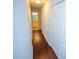Clean hallway with light walls and wood-look flooring at 6220 Sweden Dr, Raleigh, NC 27612