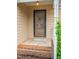 Brick steps leading to the front door with a glass storm door and welcome mat at 6220 Sweden Dr, Raleigh, NC 27612