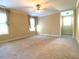 Spacious bedroom with ceiling fan and large windows at 3318 Denada Path, Durham, NC 27707