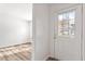 Bright entryway with white walls, light wood flooring, and an interior door at 14 Stone Village Ct, Durham, NC 27704