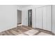 Bedroom with light wood flooring, white walls, and a double door closet at 14 Stone Village Ct, Durham, NC 27704