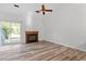 Living room with fireplace, sliding glass door, and ceiling fan at 14 Stone Village Ct, Durham, NC 27704