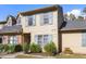 Tan two-story townhome with gray shutters and landscaping at 14 Stone Village Ct, Durham, NC 27704