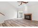 Living room with fireplace, sliding glass door, and ceiling fan at 14 Stone Village Ct, Durham, NC 27704