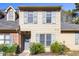 Tan two-story townhome with gray shutters and landscaping at 14 Stone Village Ct, Durham, NC 27704