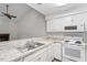 White kitchen with granite countertops and modern appliances at 14 Stone Village Ct, Durham, NC 27704