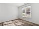 Bright bedroom with light wood flooring and two large windows at 14 Stone Village Ct, Durham, NC 27704