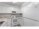 White kitchen with granite countertops and modern appliances at 14 Stone Village Ct, Durham, NC 27704