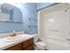 Clean bathroom with shower/tub combo, vanity, and glass shelves at 14 Stone Village Ct, Durham, NC 27704