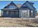 Two-story home with gray siding, stone accents, and a covered porch at 20 Water Willow Ln, Zebulon, NC 27597