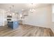 Modern kitchen with gray cabinets, a blue island, and stainless steel appliances at 33 Barony Ln, Smithfield, NC 27577