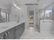 Spa-like bathroom with double vanity, large shower, and marble tile at 5100 Grist Stone Way, Youngsville, NC 27596