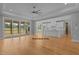 Open living room with hardwood floors, kitchen view, access to screened porch at 5100 Grist Stone Way, Youngsville, NC 27596
